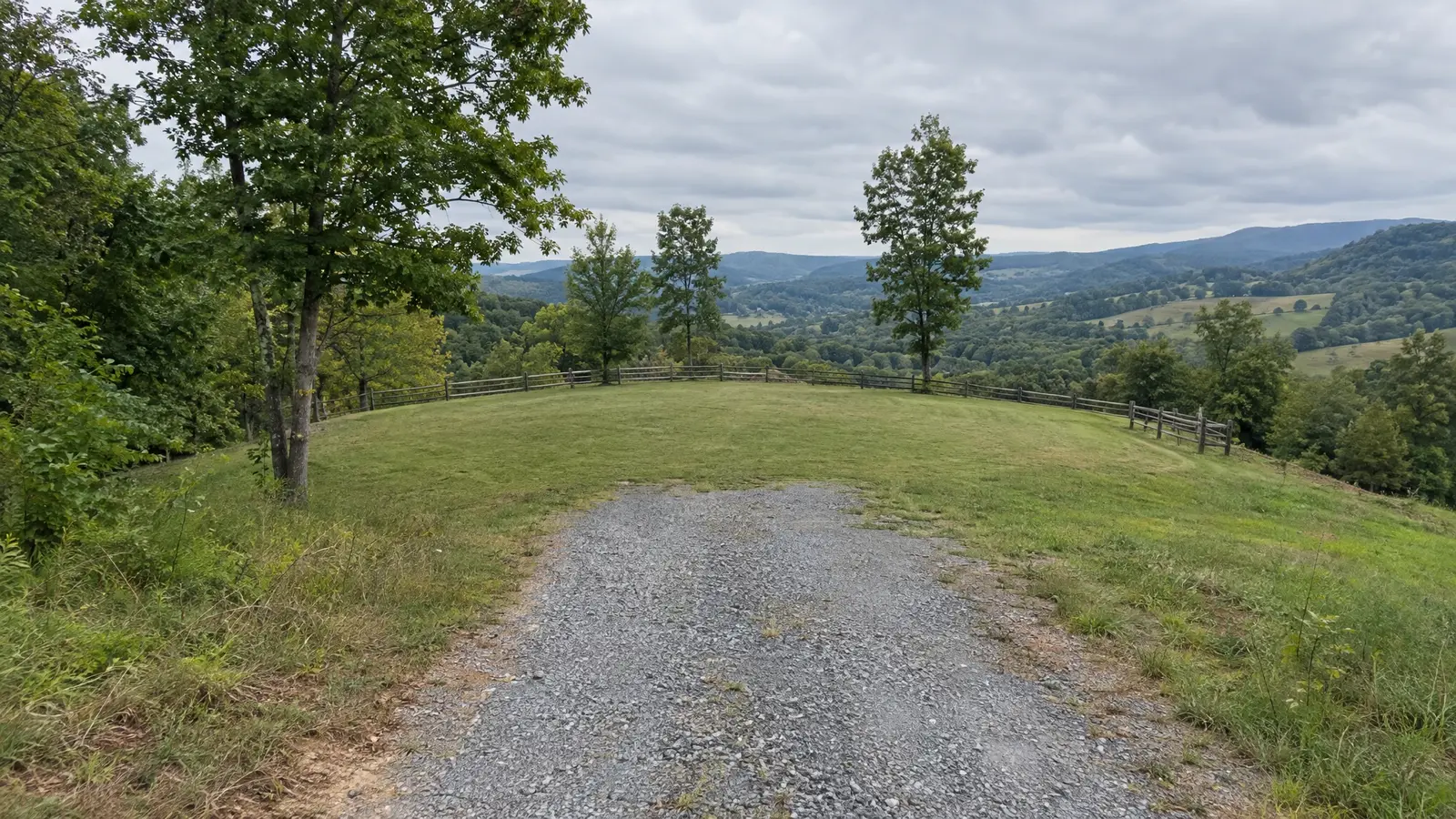 Before: a homesite at the end of a gravel drive with an empty grassy building area