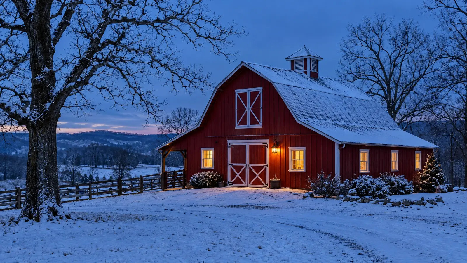 A red barn in winter with warm light glowing from the windows A red barn in winter with warm light glowing from the windows