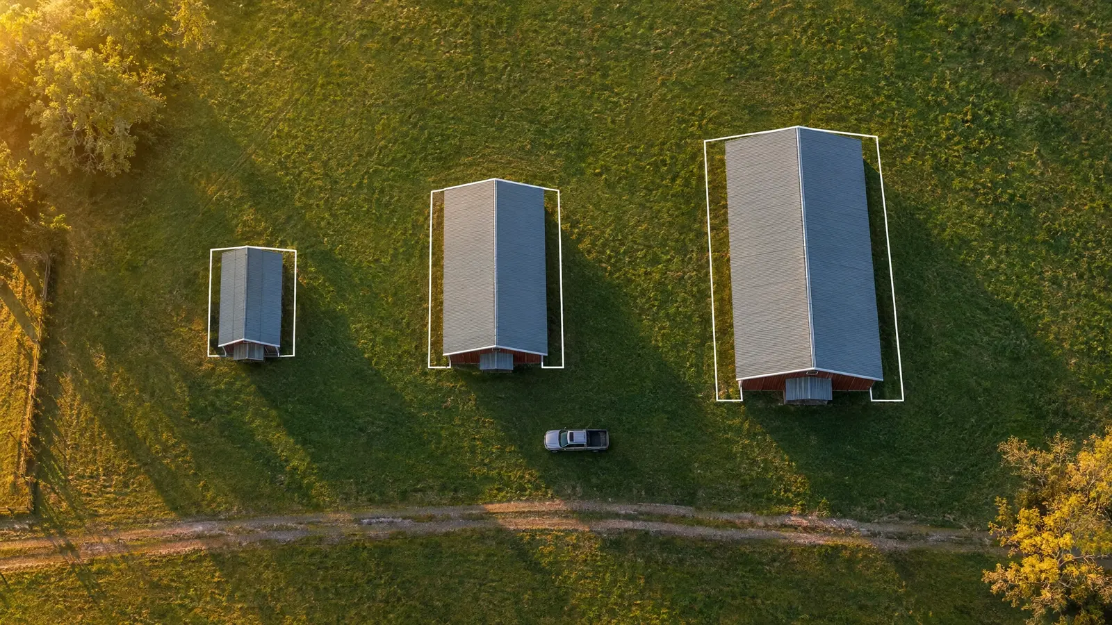 Barn resource guides | Music City Barns An aerial view of three barn footprints outlined in a green field with a pickup truck for scale